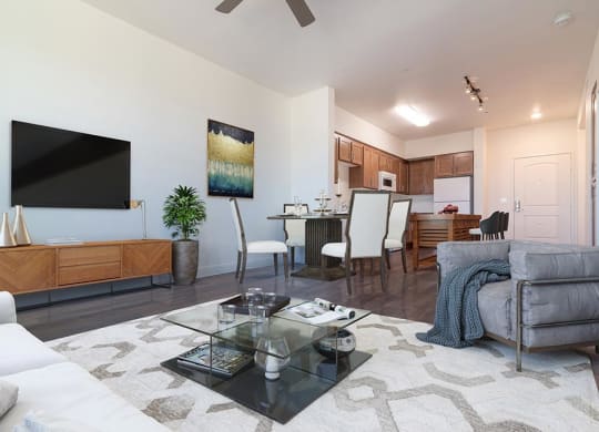 Living room with couch and table at Portola Senior Apartments, Carlsbad